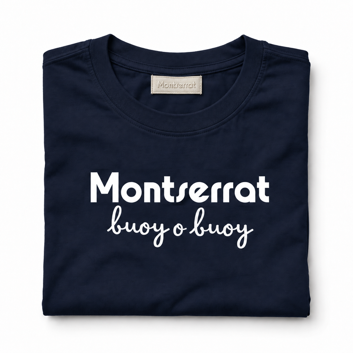 A folded navy blue t-shirt with white printed text reading 'Montserrat' and 'buoy o buoy' on a clean white background.